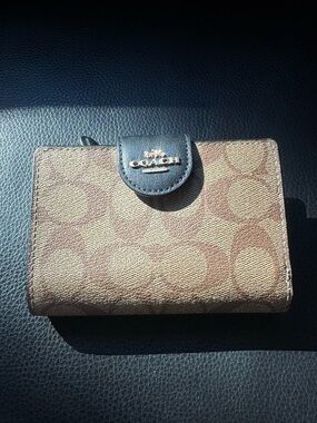 COACH Signature Canvas Small Wallet in Brown.